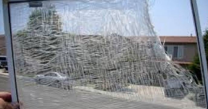 Torn window screen ready for repair and rescreening in DuPage, Kane, Kendall and Lake County IL